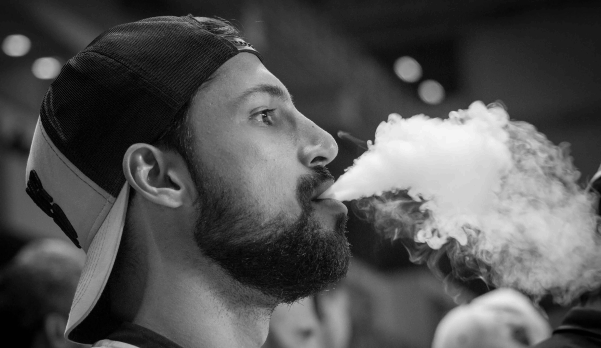 man holding a vape